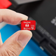 a person holds a sandisk microsd memory card for nintendo switch